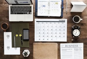 day book calendar and laptop on desk