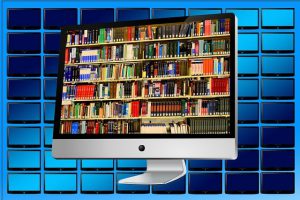 library of books on computer monitor