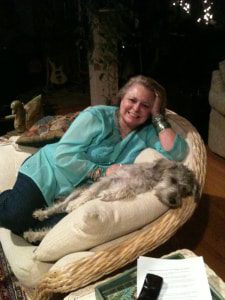 relaxed dog on chair with woman