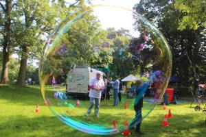 family playing soap bubbles outdoors