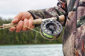 hand and fishing reel